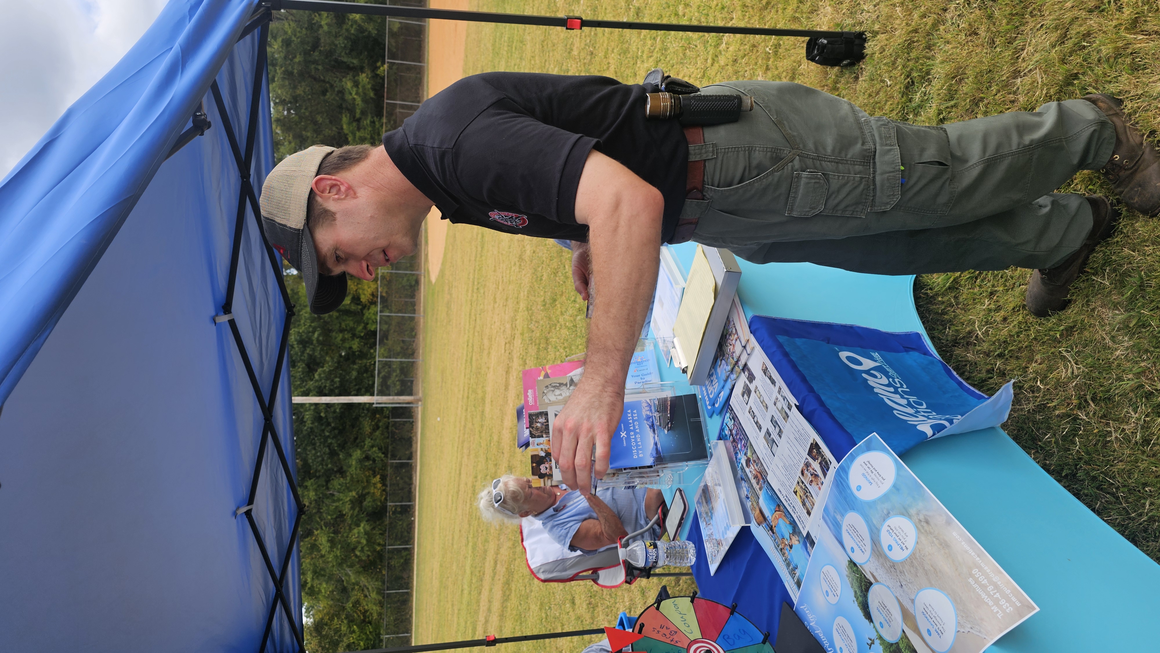 Daniel Richardson talking with a supporter at a community event